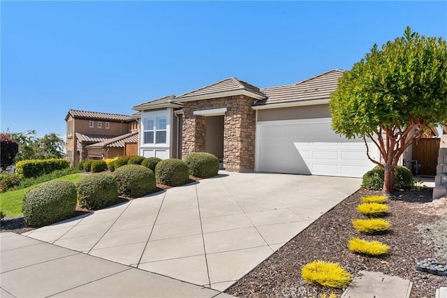905 Romneya Ln, Santa Maria, CA 93455 - view of front facade with driveway, an attached garage, stone siding, and a tile roof