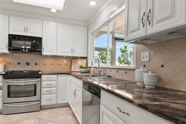 1525 E Baldwin Ave, Orange, CA 92865 - kitchen featuring stainless steel appliances, a sink, white cabinets, decorative backsplash, and recessed lighting