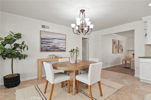 1525 E Baldwin Ave, Orange, CA 92865 - dining room featuring light tile patterned flooring, ornamental molding, a chandelier, and baseboards