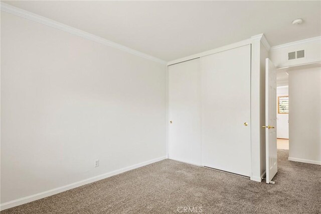 1525 E Baldwin Ave, Orange, CA 92865 - unfurnished bedroom featuring ornamental molding, carpet, baseboards, and a closet
