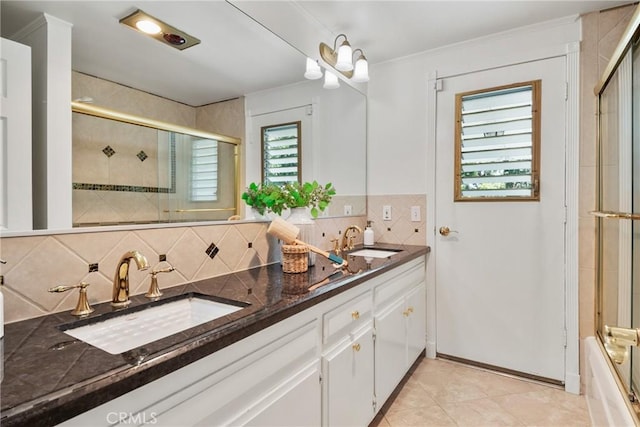 1525 E Baldwin Ave, Orange, CA 92865 - bathroom with tasteful backsplash, double vanity, tile patterned floors, ornamental molding, and bath / shower combo with glass door