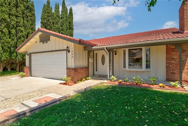 1525 E Baldwin Ave, Orange, CA 92865 - view of front facade with brick siding, a tiled roof, a garage, and driveway