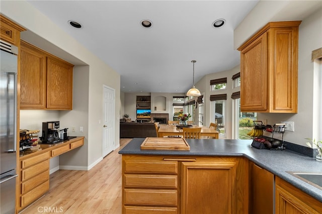823 Sonora Ct, San Dimas, CA 91773 - kitchen featuring stainless steel built in refrigerator, a peninsula, light wood finished floors, open floor plan, and dark countertops
