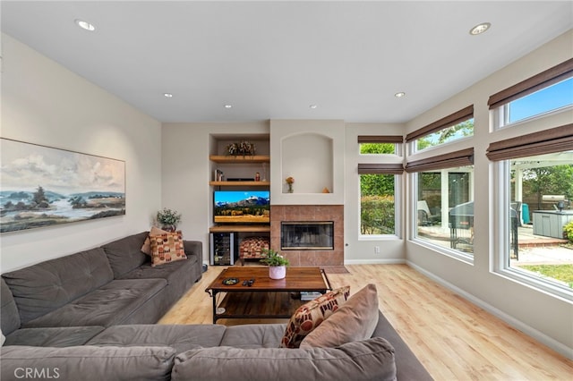 823 Sonora Ct, San Dimas, CA 91773 - living area with wood finished floors, baseboards, recessed lighting, a fireplace, and built in features