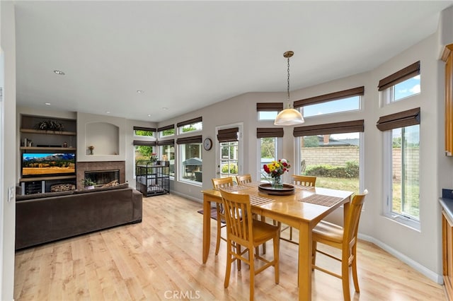 823 Sonora Ct, San Dimas, CA 91773 - dining area featuring healthy amount of natural light, light wood-type flooring, a glass covered fireplace, and baseboards