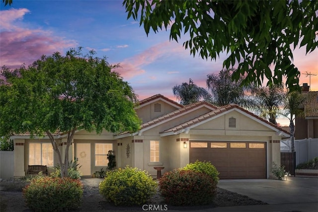 25977 Monaco Way, Murrieta, CA 92563 - view of front of home featuring a garage, stucco siding, driveway, and a tiled roof