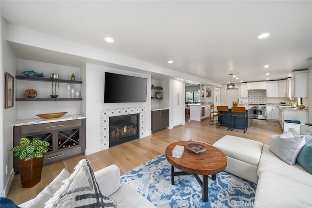 5805 Salisbury Ln, San Luis Obispo, CA 93401 - living room featuring light wood-style flooring, a tile fireplace, and recessed lighting