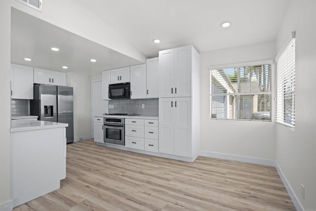 2286 Levante St, Carlsbad, CA 92009 - kitchen with stainless steel appliances, light countertops, decorative backsplash, baseboards, and white cabinets
