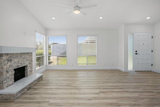 2286 Levante St, Carlsbad, CA 92009 - unfurnished living room featuring baseboards, a ceiling fan, recessed lighting, a stone fireplace, and light wood-style flooring