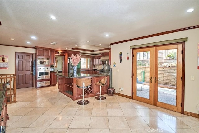 2036 S Buenos Aires Dr, Covina, CA 91724 - kitchen with stainless steel appliances, ornamental molding, open shelves, a breakfast bar, and french doors