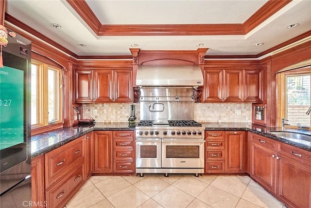 2036 S Buenos Aires Dr, Covina, CA 91724 - kitchen featuring double oven range, wall chimney range hood, a tray ceiling, ornamental molding, and a sink