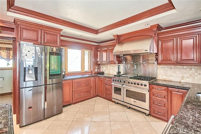 2036 S Buenos Aires Dr, Covina, CA 91724 - kitchen with appliances with stainless steel finishes, wall chimney range hood, a tray ceiling, crown molding, and tasteful backsplash