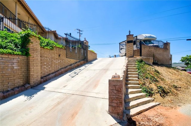 2036 S Buenos Aires Dr, Covina, CA 91724 - view of concrete driveway with stairway and a gated entry
