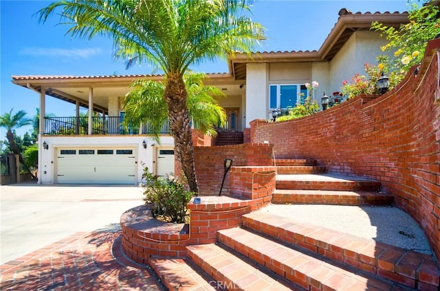 2036 S Buenos Aires Dr, Covina, CA 91724 - view of front of house featuring stucco siding, driveway, an attached garage, and a tile roof
