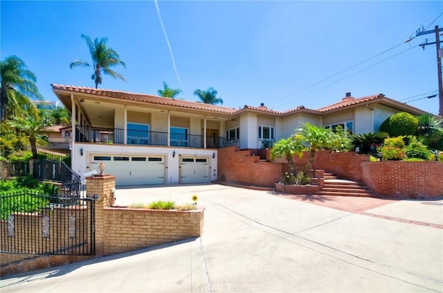 2036 S Buenos Aires Dr, Covina, CA 91724 - mediterranean / spanish house with stucco siding, driveway, an attached garage, and a balcony