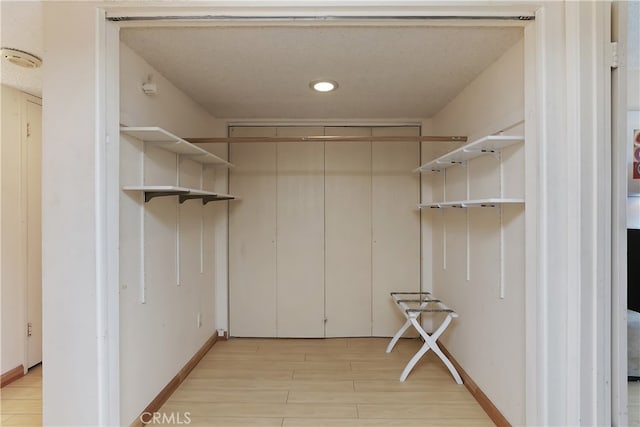 277 E Alejo Rd Unit 212, Palm Springs, CA 92262 - walk in closet featuring light wood-style flooring
