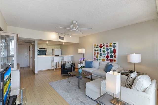277 E Alejo Rd Unit 212, Palm Springs, CA 92262 - living room featuring ceiling fan, a textured ceiling, track lighting, and light wood-type flooring