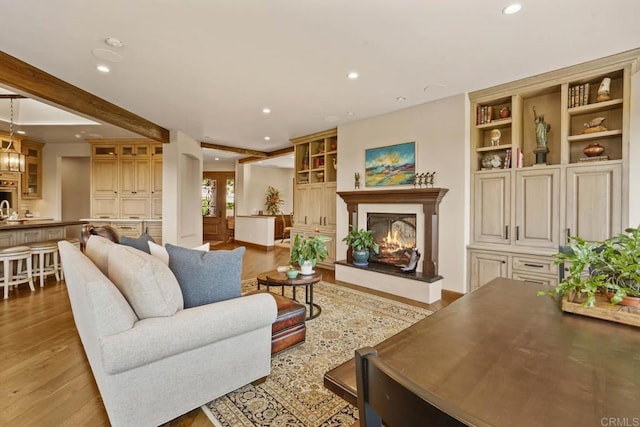 4652 Resmar Rd, La Mesa, CA 91941 - living room featuring recessed lighting, wood finished floors, a warm lit fireplace, and built in features