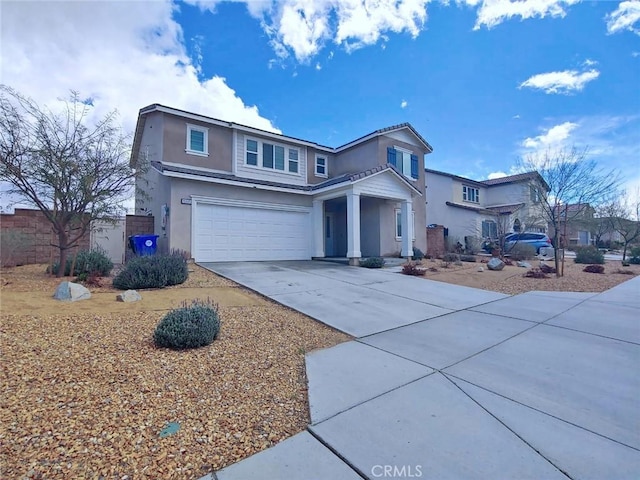 15555 San Diego Ln, Victorville, CA 92394 - traditional-style home with stucco siding, an attached garage, and concrete driveway