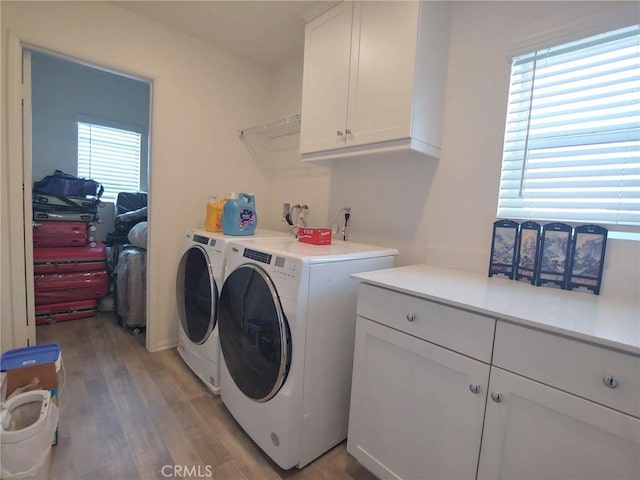 15555 San Diego Ln, Victorville, CA 92394 - laundry area featuring cabinet space, washer and dryer, and light wood finished floors