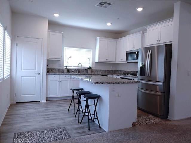 15555 San Diego Ln, Victorville, CA 92394 - kitchen with stainless steel appliances, white cabinets, and recessed lighting