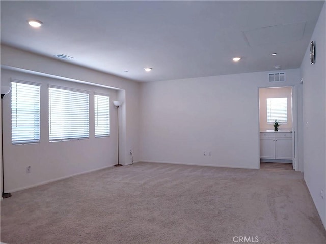 15555 San Diego Ln, Victorville, CA 92394 - unfurnished room featuring light colored carpet, healthy amount of natural light, recessed lighting, and baseboards