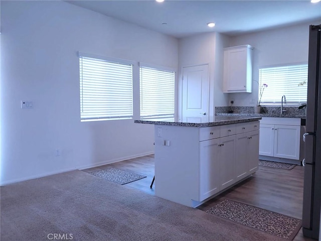 15555 San Diego Ln, Victorville, CA 92394 - kitchen with white cabinetry, a sink, freestanding refrigerator, wood finished floors, and recessed lighting