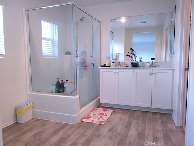 15555 San Diego Ln, Victorville, CA 92394 - full bath with a shower stall, double vanity, wood finished floors, and baseboards
