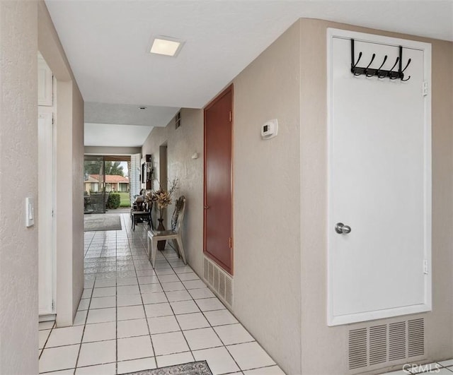 28 Malaga Dr, Rancho Mirage, CA 92270 - corridor featuring light tile patterned floors and a textured wall