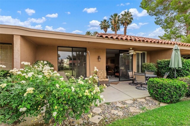 28 Malaga Dr, Rancho Mirage, CA 92270 - back of property with stucco siding, ceiling fan, a patio, and a tile roof