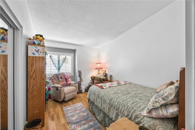 17477 Owl Tree Rd, Riverside, CA 92504 - bedroom with a textured ceiling and wood finished floors