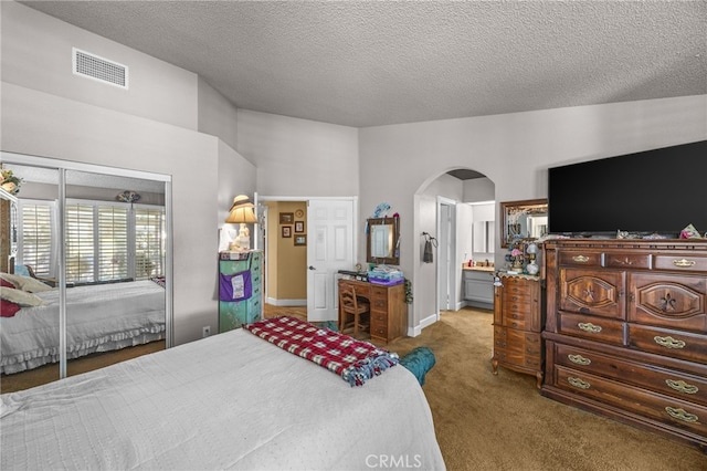17477 Owl Tree Rd, Riverside, CA 92504 - bedroom featuring arched walkways, carpet, a textured ceiling, a closet, and baseboards