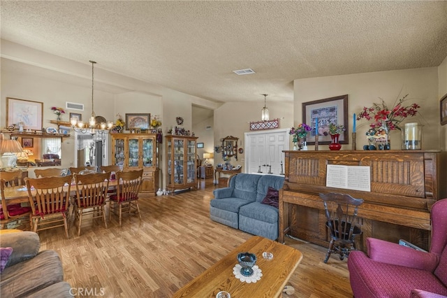 17477 Owl Tree Rd, Riverside, CA 92504 - living room with a chandelier, wood finished floors, and a textured ceiling