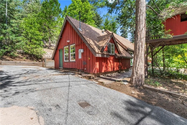 118 E Ln, Lake Arrowhead, CA 92352 - view of front of house featuring board and batten siding and a shingled roof