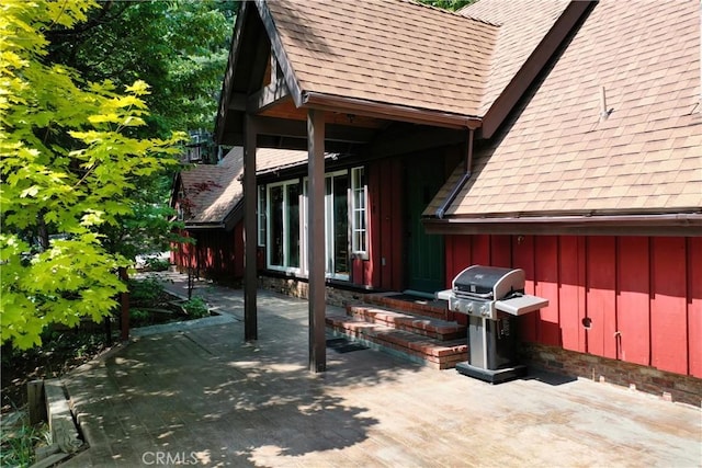 118 E Ln, Lake Arrowhead, CA 92352 - view of side of property with roof with shingles, board and batten siding, and a patio