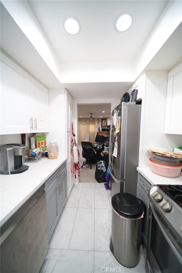 532 Venice Way Unit 8, Inglewood, CA 90302 - kitchen featuring appliances with stainless steel finishes, light marble finish floors, white cabinetry, and light countertops