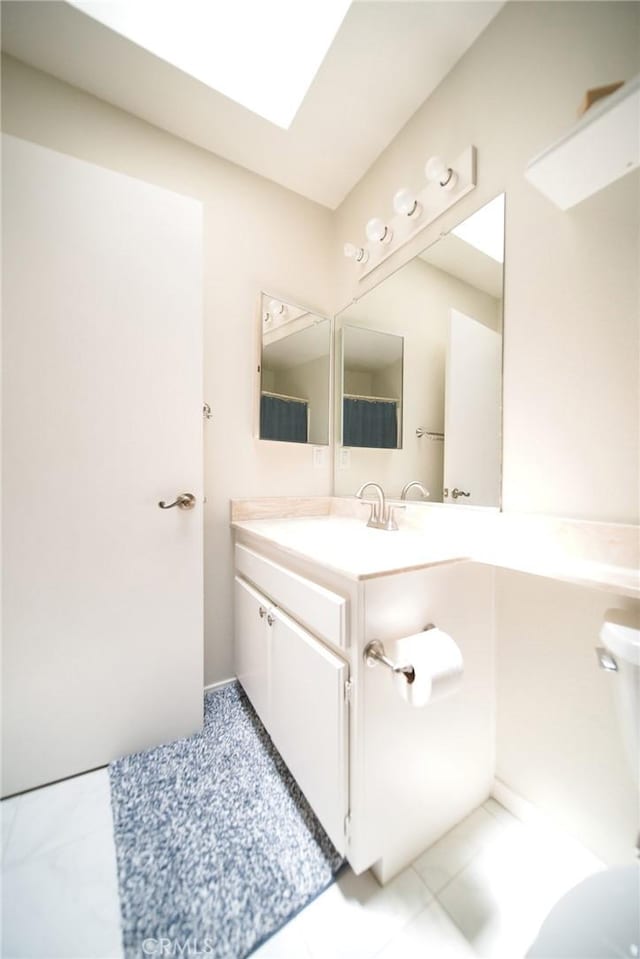 532 Venice Way Unit 8, Inglewood, CA 90302 - bathroom featuring vanity, tile patterned flooring, and a skylight