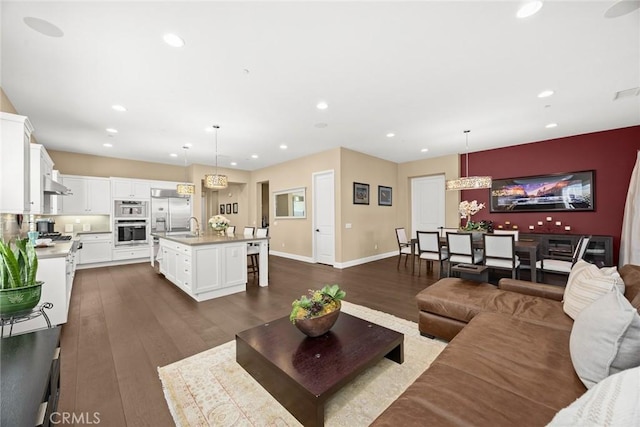 1252 N Lindley St, Azusa, CA 91702 - living area with dark wood finished floors, recessed lighting, and baseboards