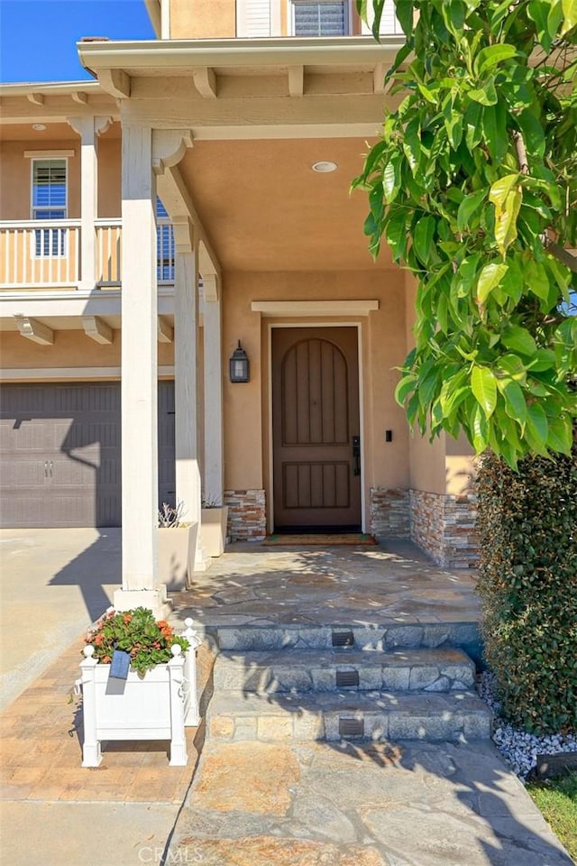 1252 N Lindley St, Azusa, CA 91702 - property entrance with stucco siding, a garage, and concrete driveway