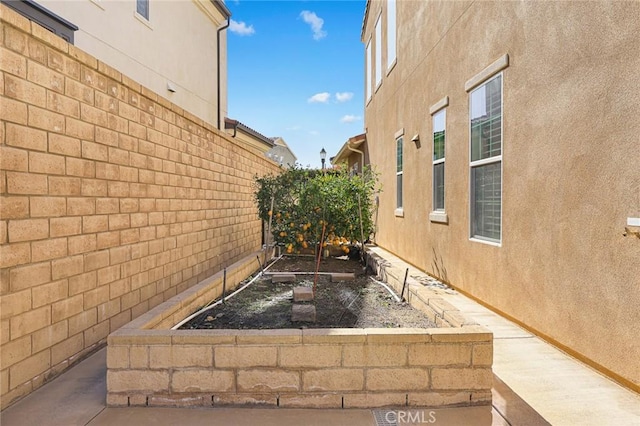 1252 N Lindley St, Azusa, CA 91702 - view of home's exterior featuring a fenced backyard, a vegetable garden, and stucco siding