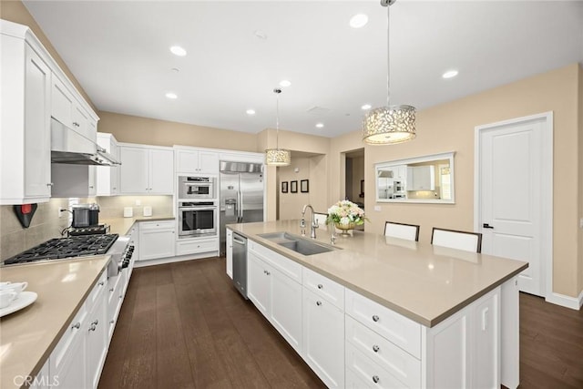 1252 N Lindley St, Azusa, CA 91702 - kitchen with a sink, stainless steel appliances, dark wood-type flooring, white cabinetry, and a large island with sink