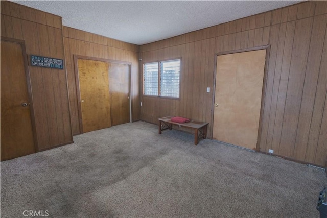 1248 E 65th St, Los Angeles, CA 90001 - carpeted entrance foyer featuring wooden walls and a textured ceiling