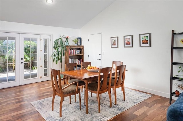 24214 Dalgo Dr, Valencia, CA 91355 - dining space featuring french doors, lofted ceiling, wood finished floors, baseboards, and recessed lighting