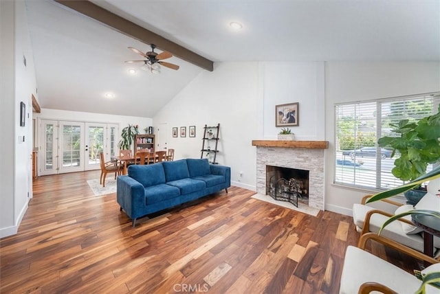 24214 Dalgo Dr, Valencia, CA 91355 - living room with beamed ceiling, ceiling fan, a stone fireplace, healthy amount of natural light, and wood finished floors