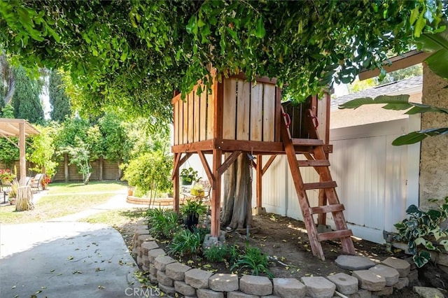 24214 Dalgo Dr, Valencia, CA 91355 - view of playground featuring a fenced backyard and a patio area
