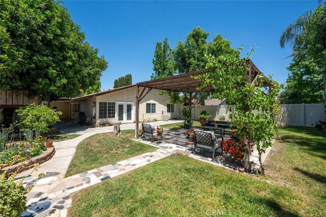 24214 Dalgo Dr, Valencia, CA 91355 - back of property featuring french doors, a patio area, stucco siding, and a pergola