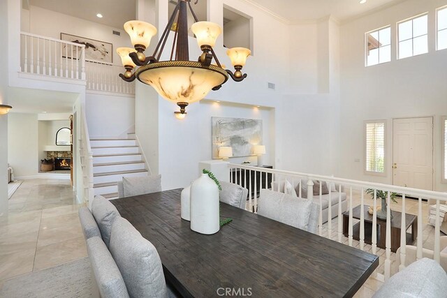 1019 N Sonora Cir, Orange, CA 92869 - dining space with a towering ceiling, stairway, crown molding, and recessed lighting