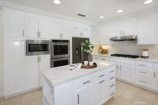 1019 N Sonora Cir, Orange, CA 92869 - kitchen featuring appliances with stainless steel finishes, under cabinet range hood, light tile patterned floors, white cabinets, and recessed lighting