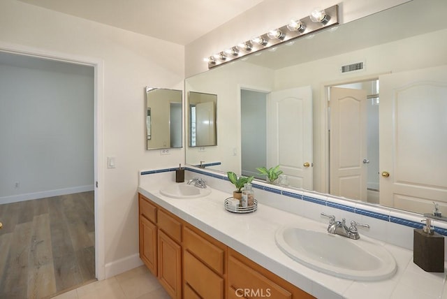 1019 N Sonora Cir, Orange, CA 92869 - bathroom featuring double vanity and baseboards