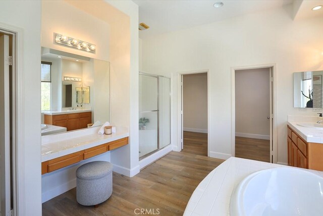 1019 N Sonora Cir, Orange, CA 92869 - full bath with wood finished floors, a stall shower, vanity, and a bath
